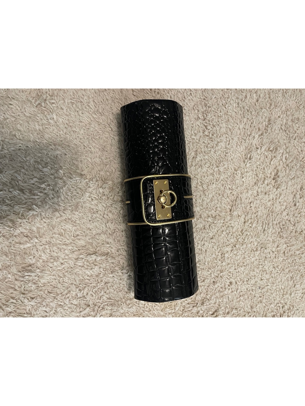 Arden B Black and Gold front buckle Cylindrical Clutch
